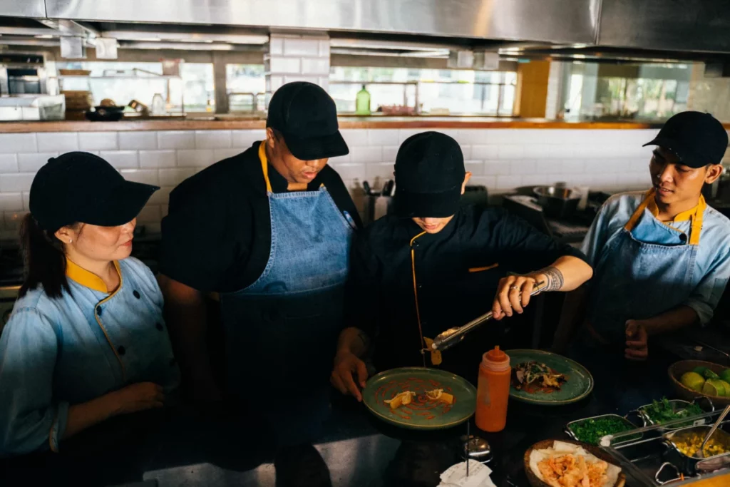 Brigade de cuisine dressant des assiettes gastronomiques, à l'image du restaurant de Tim Boury